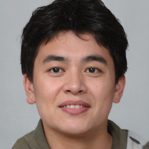 Joyful asian young-adult male with short  brown hair and brown eyes