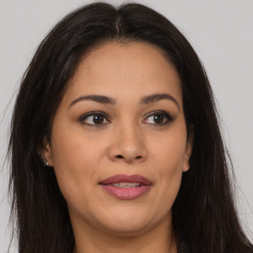 Joyful latino young-adult female with long  brown hair and brown eyes