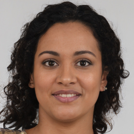 Joyful latino young-adult female with medium  brown hair and brown eyes