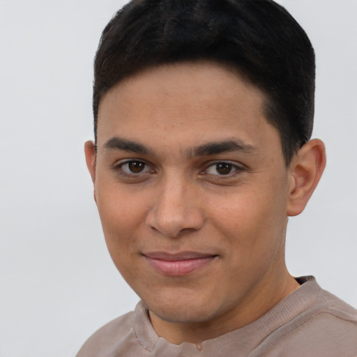 Joyful latino young-adult male with short  brown hair and brown eyes
