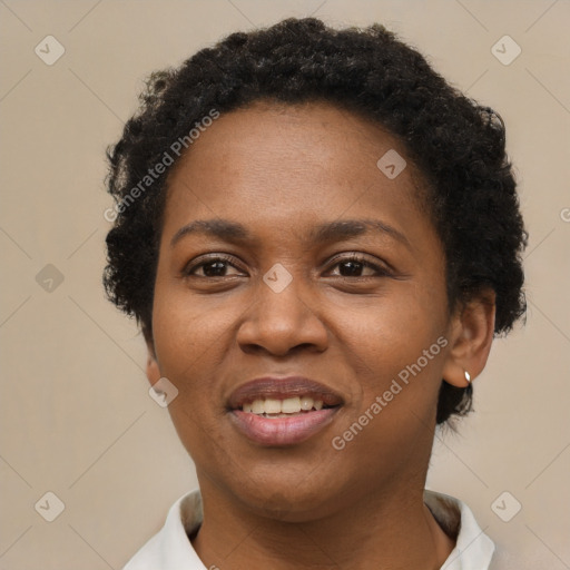 Joyful black adult female with short  brown hair and brown eyes