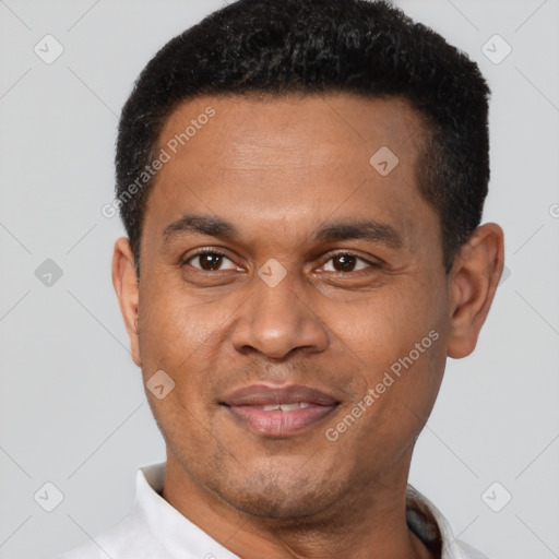 Joyful latino young-adult male with short  brown hair and brown eyes