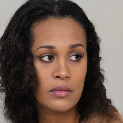 Neutral black young-adult female with long  brown hair and brown eyes