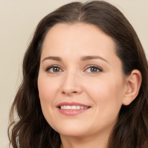 Joyful white young-adult female with long  brown hair and brown eyes