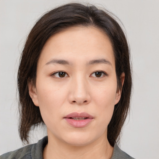 Neutral asian young-adult female with medium  brown hair and brown eyes