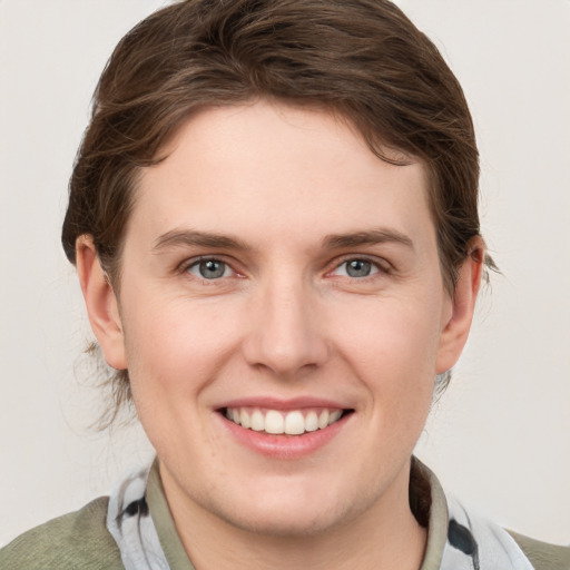 Joyful white young-adult female with short  brown hair and grey eyes