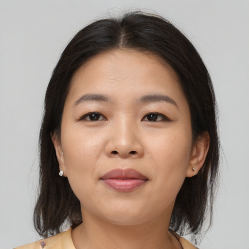 Joyful asian young-adult female with medium  brown hair and brown eyes
