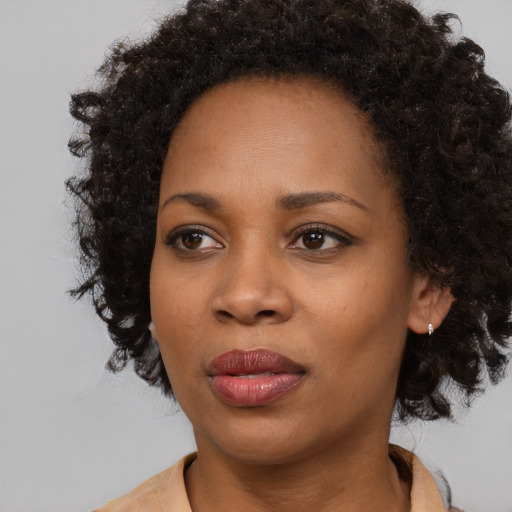 Joyful black young-adult female with medium  black hair and brown eyes