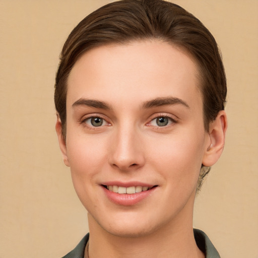 Joyful white young-adult female with short  brown hair and grey eyes