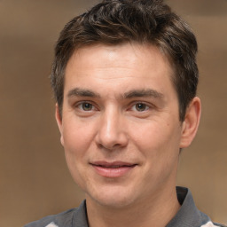 Joyful white adult male with short  brown hair and brown eyes