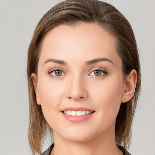 Joyful white young-adult female with medium  brown hair and blue eyes