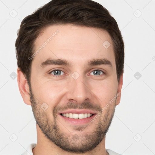 Joyful white young-adult male with short  brown hair and grey eyes