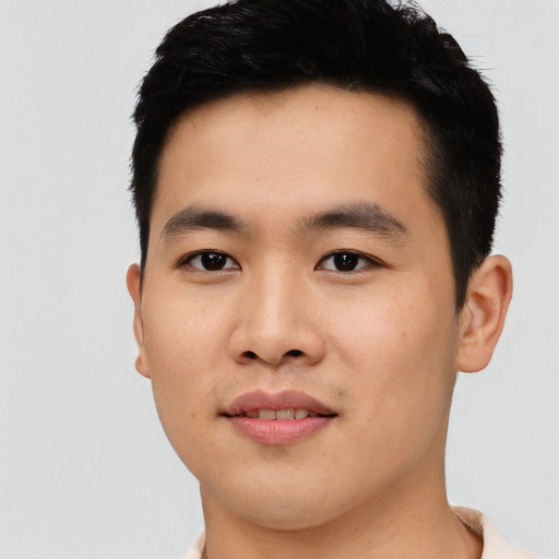 Joyful asian young-adult male with short  black hair and brown eyes