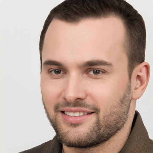 Joyful white young-adult male with short  brown hair and brown eyes