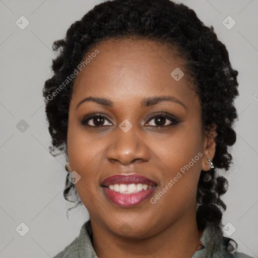 Joyful black young-adult female with long  black hair and brown eyes