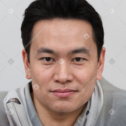 Joyful latino young-adult male with short  brown hair and brown eyes