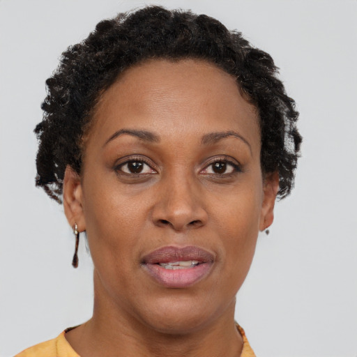 Joyful black adult female with short  brown hair and brown eyes