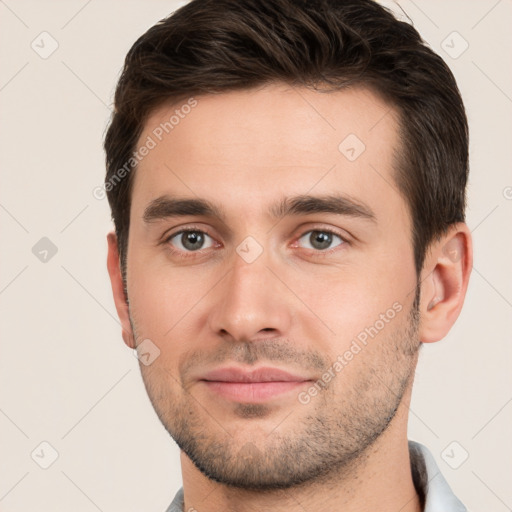 Joyful white young-adult male with short  brown hair and brown eyes