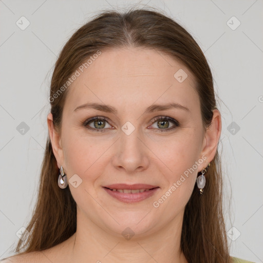 Joyful white adult female with long  brown hair and green eyes