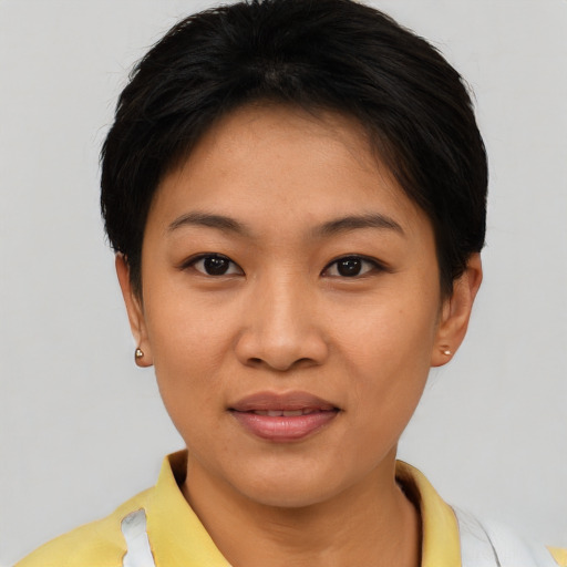 Joyful asian young-adult female with short  brown hair and brown eyes