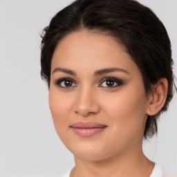 Joyful white young-adult female with medium  brown hair and brown eyes