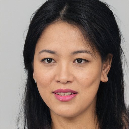 Joyful asian young-adult female with long  brown hair and brown eyes