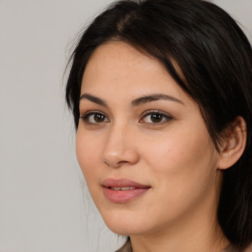 Joyful white young-adult female with long  black hair and brown eyes