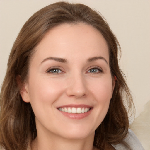 Joyful white young-adult female with long  brown hair and brown eyes