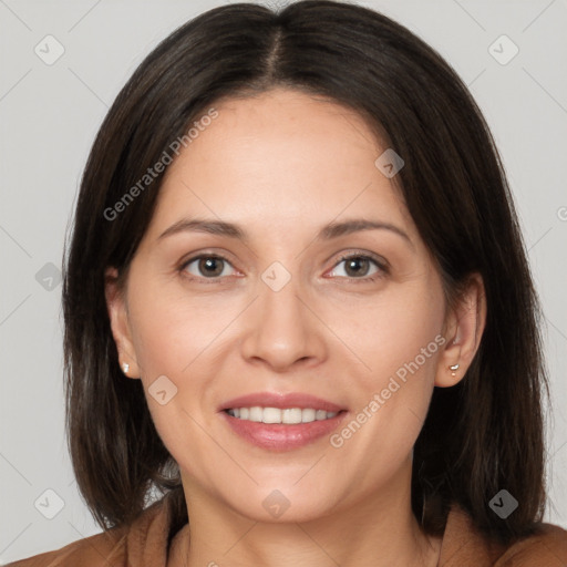 Joyful white adult female with long  brown hair and brown eyes