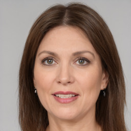 Joyful white adult female with medium  brown hair and grey eyes