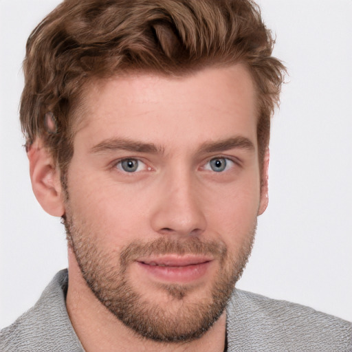 Joyful white young-adult male with short  brown hair and blue eyes