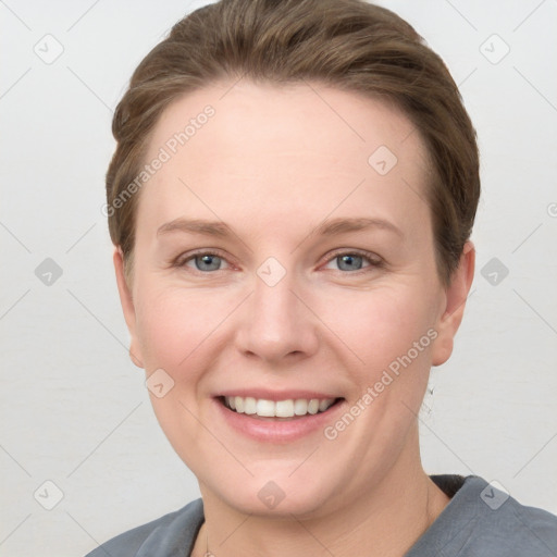 Joyful white young-adult female with short  brown hair and grey eyes