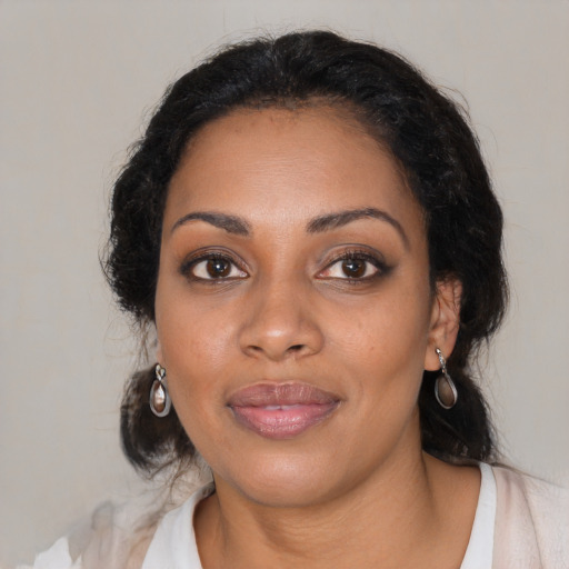 Joyful black young-adult female with medium  brown hair and brown eyes