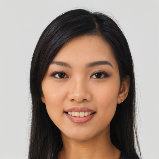Joyful asian young-adult female with long  black hair and brown eyes