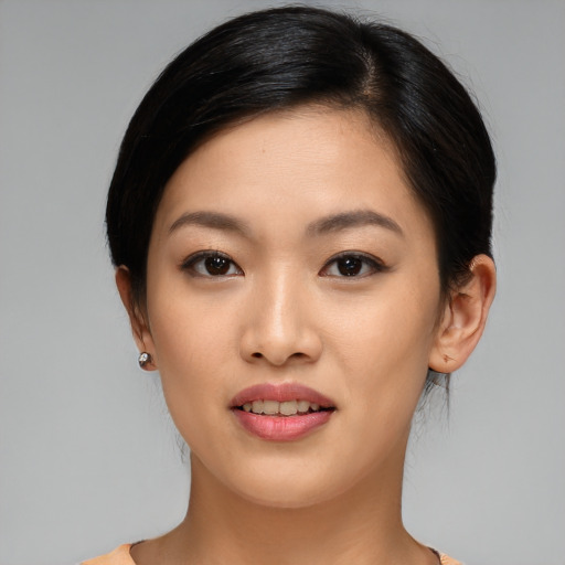 Joyful asian young-adult female with medium  black hair and brown eyes