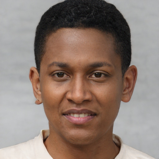 Joyful black young-adult male with short  brown hair and brown eyes