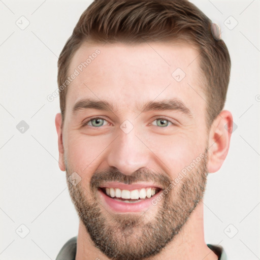 Joyful white young-adult male with short  brown hair and grey eyes