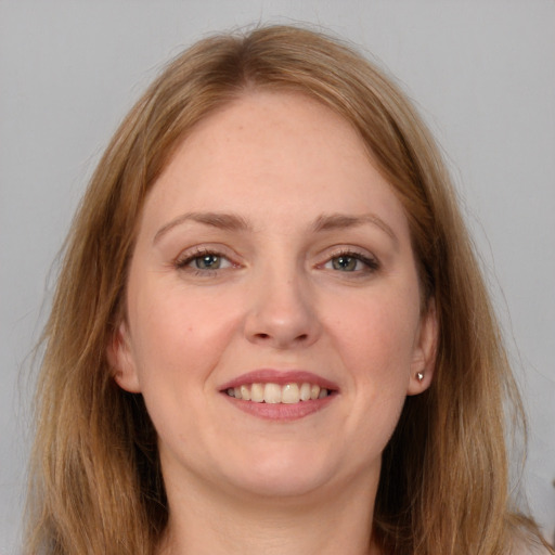 Joyful white young-adult female with long  brown hair and grey eyes