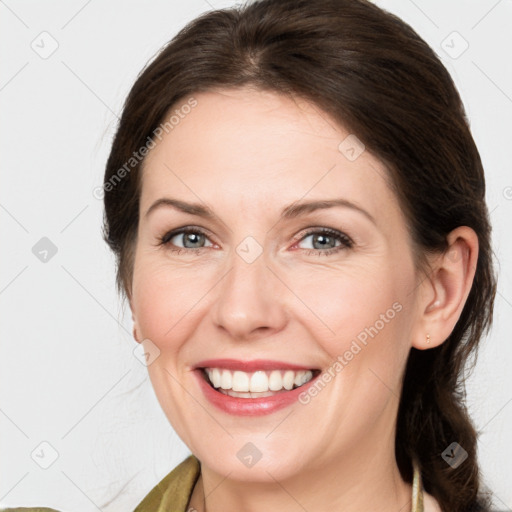 Joyful white young-adult female with medium  brown hair and green eyes