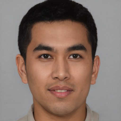 Joyful latino young-adult male with short  brown hair and brown eyes