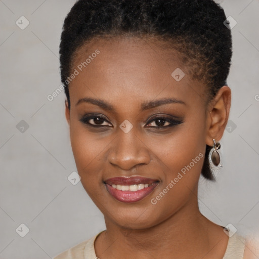 Joyful black young-adult female with short  brown hair and brown eyes