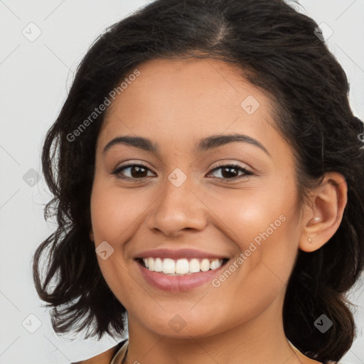 Joyful latino young-adult female with long  brown hair and brown eyes