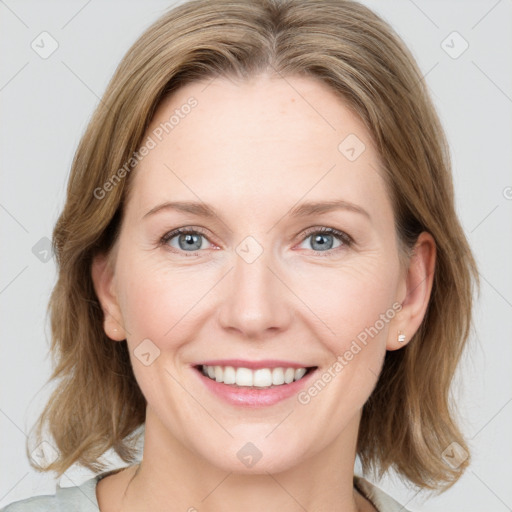 Joyful white young-adult female with medium  brown hair and blue eyes