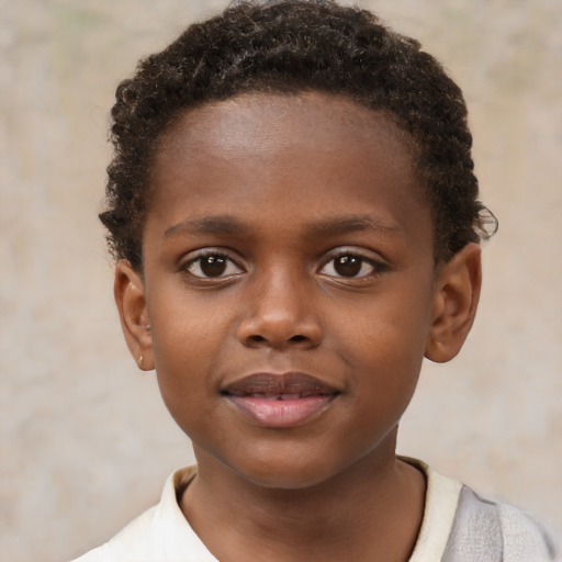 Joyful black child male with short  brown hair and brown eyes