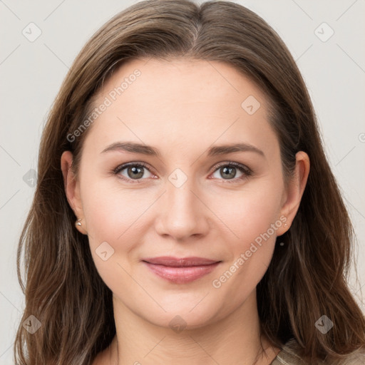 Joyful white young-adult female with long  brown hair and grey eyes