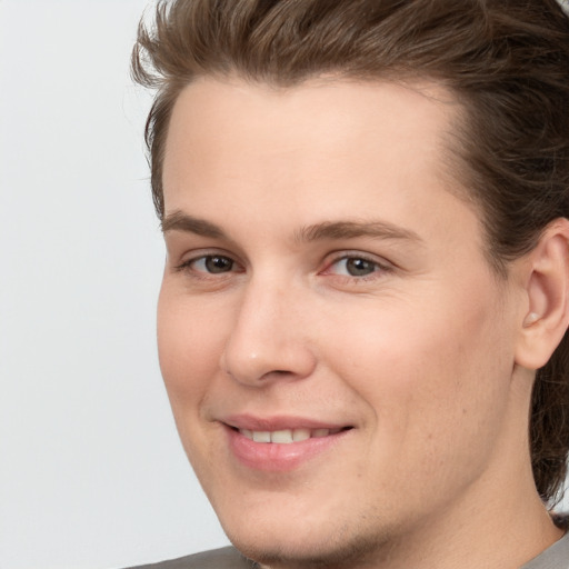 Joyful white young-adult male with medium  brown hair and brown eyes