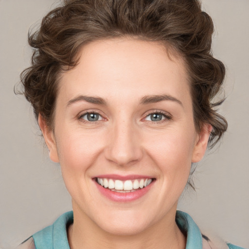 Joyful white young-adult female with medium  brown hair and blue eyes