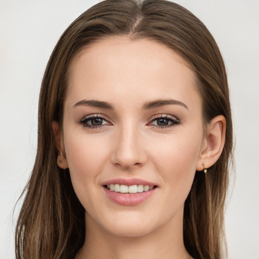 Joyful white young-adult female with long  brown hair and grey eyes