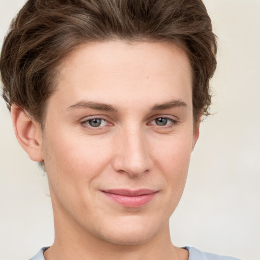 Joyful white young-adult female with short  brown hair and grey eyes