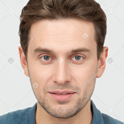 Joyful white young-adult male with short  brown hair and grey eyes